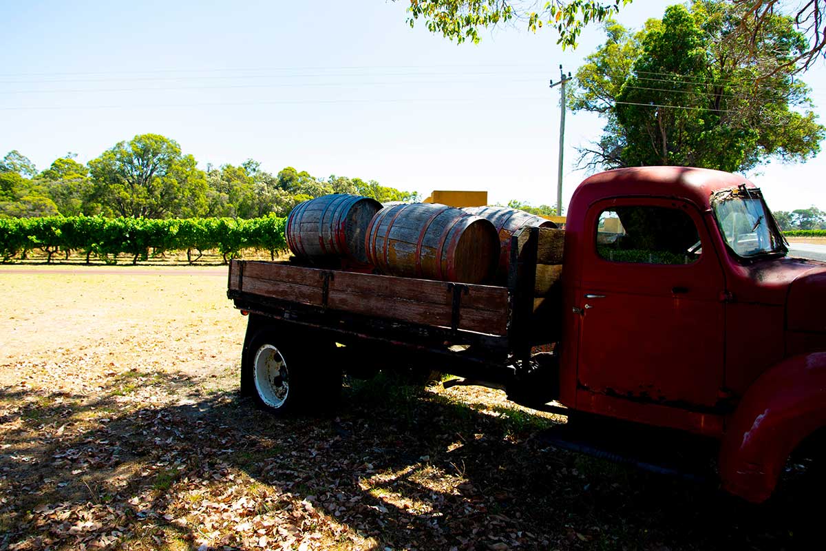 Wine barrels on a truck in a vineyard at Margaret River.